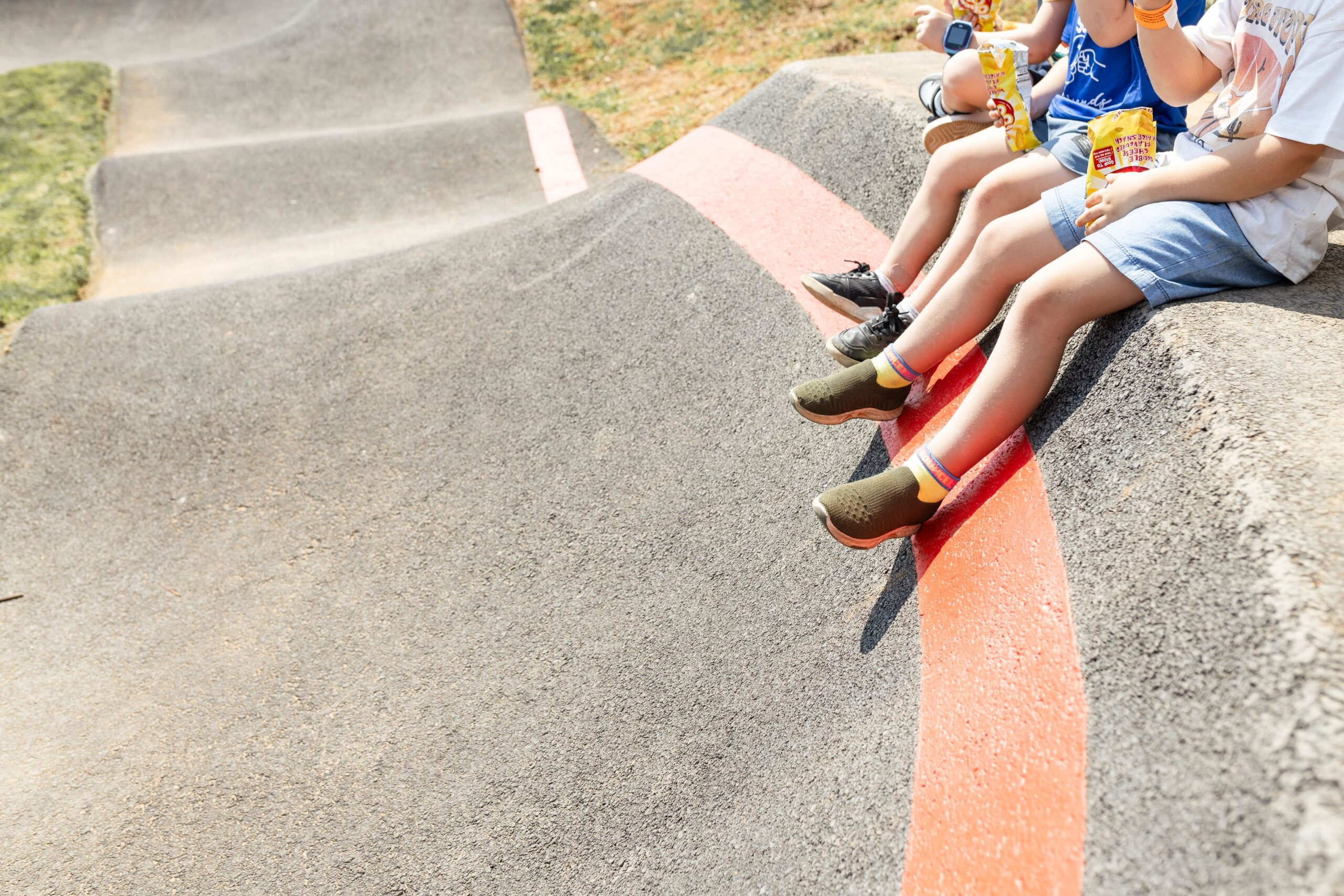 Children-Eating-Kiosk-Snacks-At-The-Park-Pump-Track